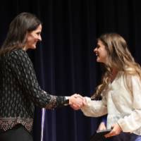 jenn handing the cord at the stage